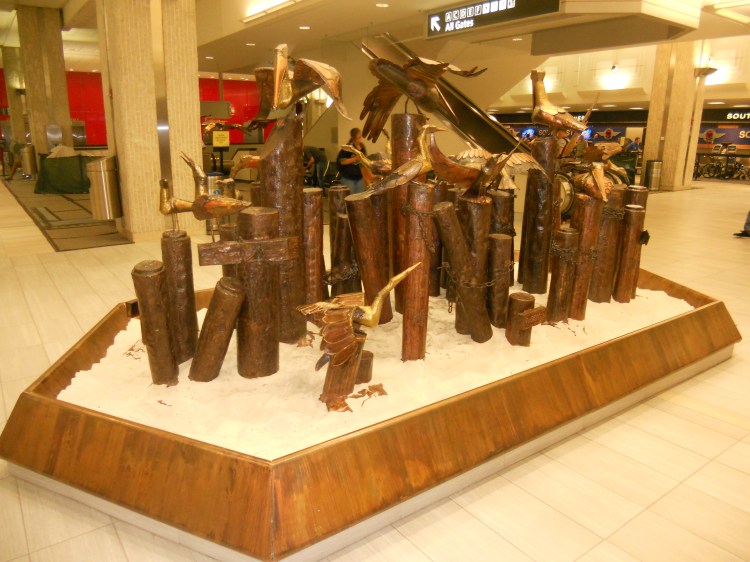 Another Roy Butler art piece on level 2 of the main terminal. Notice the red paneled walls in the background? That's one of the elevator banks. The entire main terminal complex has seen significant updates since the late 1990s. Now the complex is undergoing its most massive renovation and expansion project to date. Photo Credit: HARTride 2012.