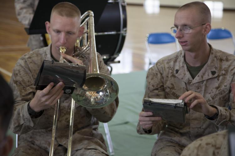 Two Marines (twin brothers) take a few moments to sharpen their music skills. Photo Credit: US Marines/Lance Cpl. Elizabeth A. Case.