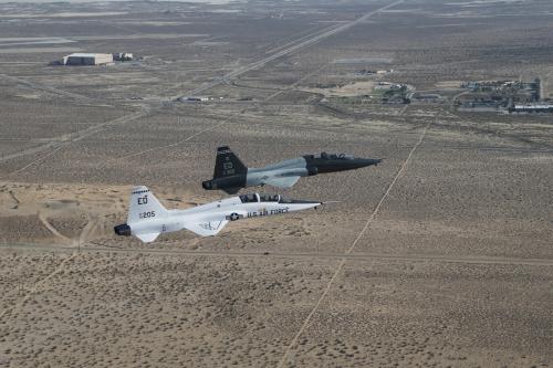 Two US Air Force jets fly side-by-side over the desert. One is a T-38 A-model and the other a T-38 C-model. Not sure which one is which though. Photo Credit: US Air Force/Bobbi Zapka.