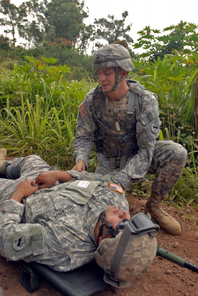 Two soldiers participate in a casualty exercise. Photo Credit: US Army.