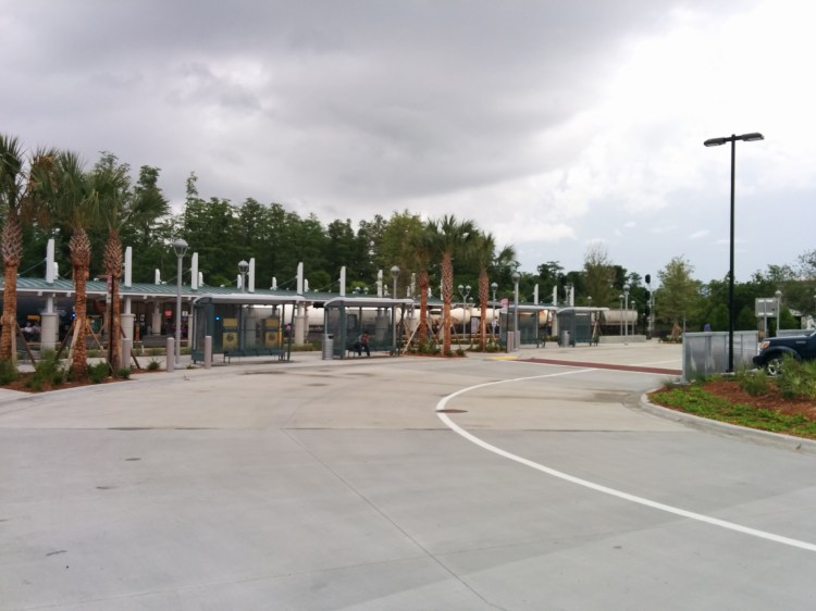 The Sand Lake Rd SunRail station and LYNX bus stop area. A Park-N-Ride lot is to my right. Photo Credit: HARTride 2012. May, 2014.