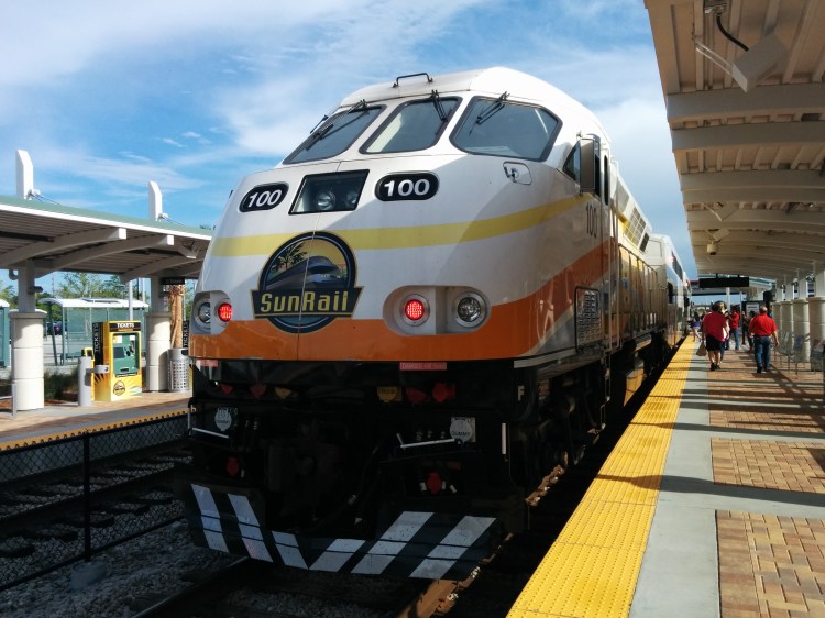 A SunRail train waits at the Sand Lake Rd station. Photo Credit: HARTride 2012.