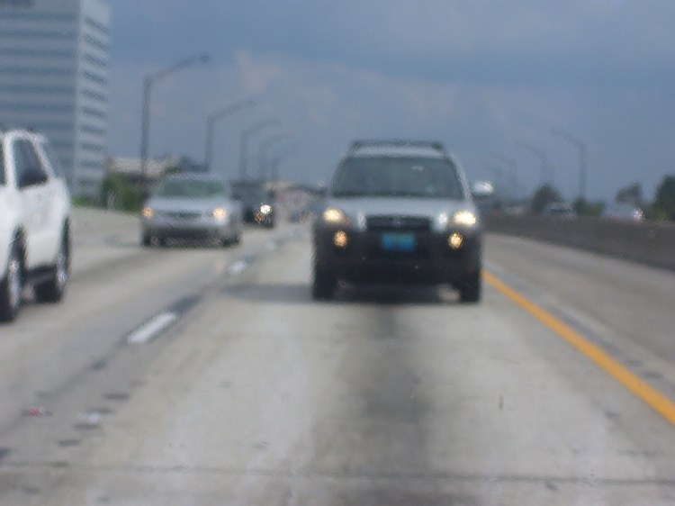 In the back passenger seat looking back as my family traveled down I-4 near downtown Orlando in 2008. Photo Credit: HARTride 2012. August, 2008.